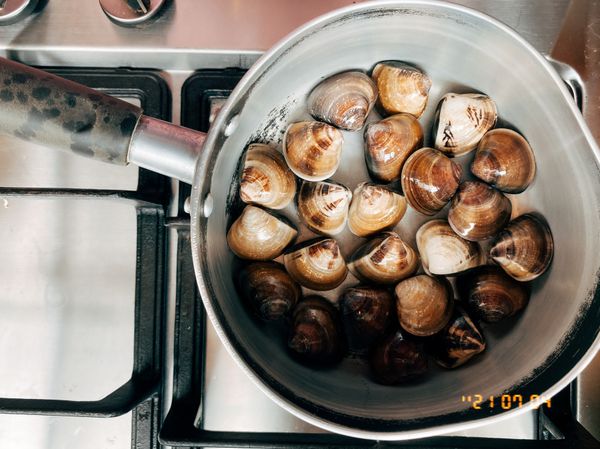 另起一鍋，完全不用加水
蓋上鍋蓋燜煮蛤蜊
蛤蜊全開後即可關火
並加入一大匙米酒