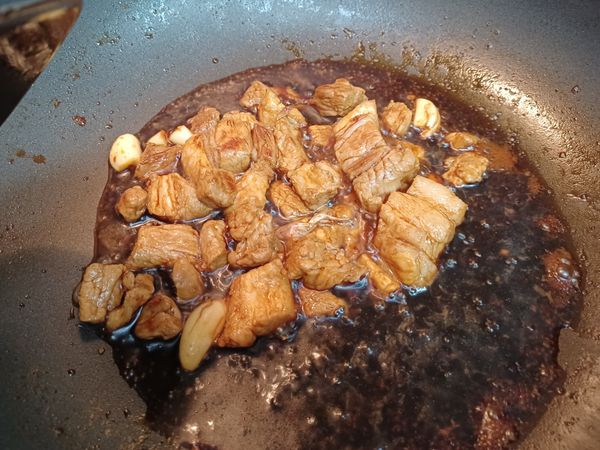 蒜頭，醬油，米酒一起下去炒一下
就放入電子鍋加蔥跟薑，再加水蓋過肉（約2.5杯），一起煮30分鐘