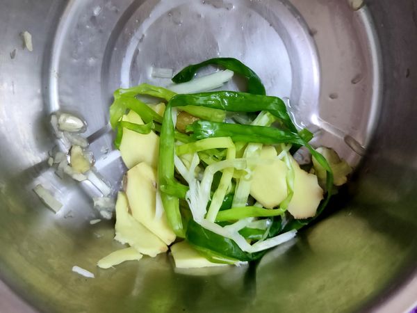 青蔥切長段、老薑切片、蒜頭拍碎，全放入鍋中，加入米酒抓一下，讓味道更出來。