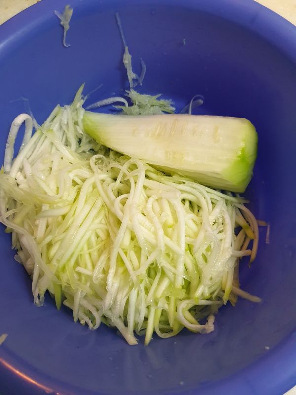 瓠瓜去皮後剖成四半，以粗孔刨絲刀刨絲(瓜瓤不要刨進去)