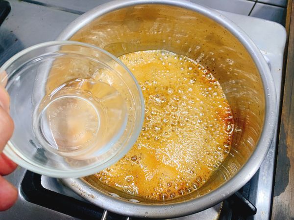 慢煮至呈黃褐色，熄火倒入熱水後攪拌均勻即為焦糖液