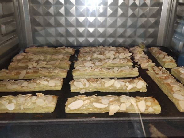 烤箱已預熱好180/170 ，鋪好的杏仁酥條放入烤箱下層，烤時15-20分。