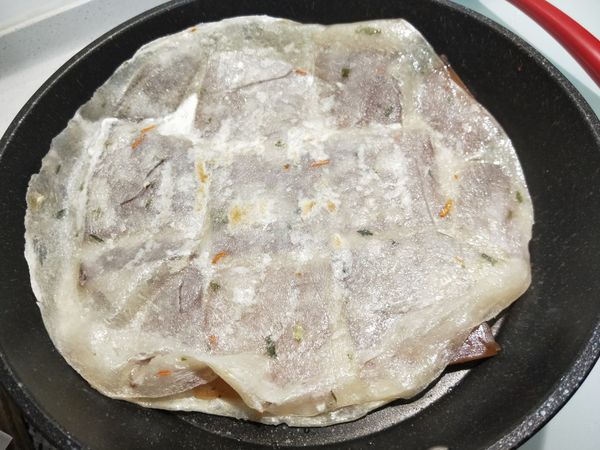 蓋上另一片蛋餅皮，微小火煎至年糕軟化