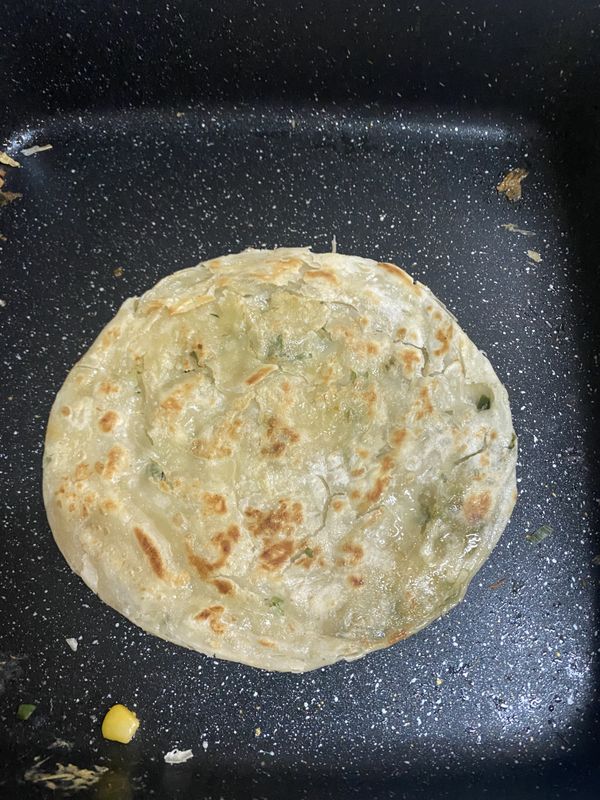 首先放少許油把抓餅雙面煎熟，煎的赤赤的最好吃，之後先盛起來。