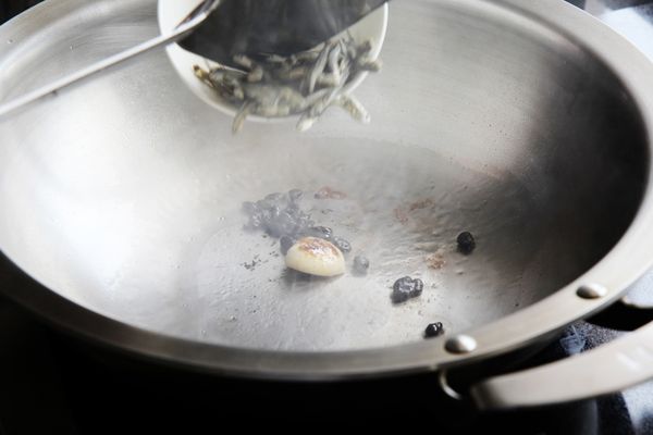 熱油鍋，先爆香蒜頭與豆豉，再加入小魚乾，炒出香味後，加入山蘇，拌炒片刻後再加入伊莉莎白辣醬，最後從鍋邊熗入米酒，即完成。