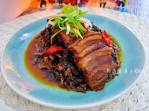 等待燉煮的時候，把蔥用可飲用水洗淨瀝乾，蔥折成一把，橫切成絲泡冷開水備用；擺盤時只需將梅干菜擺在盤裡，擺上五花肉，淋上醬汁，再放上蔥絲即可漂亮上菜。