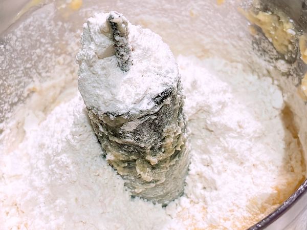 將過篩麵粉分三次加入攪拌