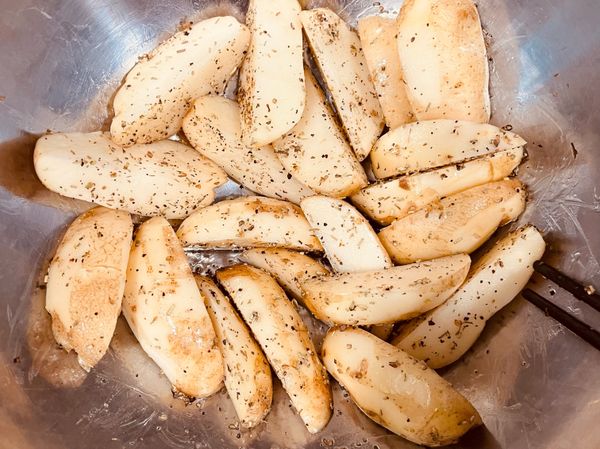 馬鈴薯用菜瓜布洗刷乾淨切片（口感可依個人喜好切厚薄度）, 再用橄欖油義式香料黑胡椒粉調味（喜歡不同口味的可以自行調味）並攪拌均勻讓每一塊切片都可以沾到香料