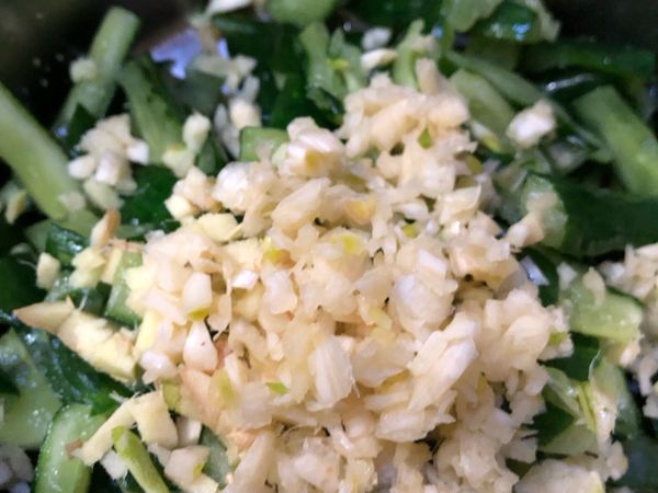 把小黃瓜的鹽份洗淨，捏乾，加入蒜末、薑末、半茶匙的鹽、糯米醋、糖、胡椒粉，用萬能的手去抓醃約3分鐘。