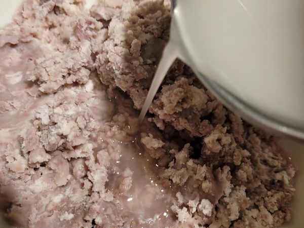 蒸熟的芋頭用叉子壓碎，加入澱粉糖水拌勻。