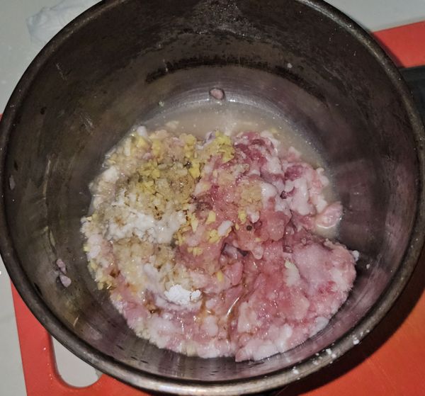 絞肉加入鹽巴.胡椒.番油.米酒.蒜末.薑末.一點點太白粉.少許的水 攪拌至醬汁被吸收後放入冰箱靜置。
