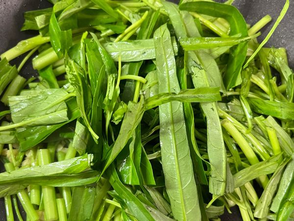 接著再倒入空心菜葉的部分拌炒並依個人喜好進行調味即可