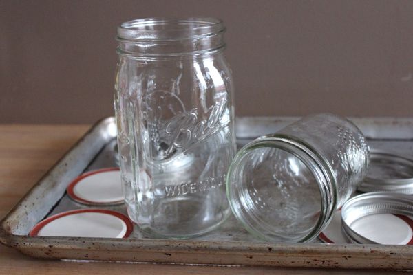 當罐子還在鍋中時，將烤箱預熱至300ºF，並準備一個乾淨的烤盤。將消毒好的玻璃罐及罐蓋從鍋中取出，並將它們放在烤盤上。*這時，您準備倒入罐中的果醬或醬汁等也應該準備在15-20分鐘完成