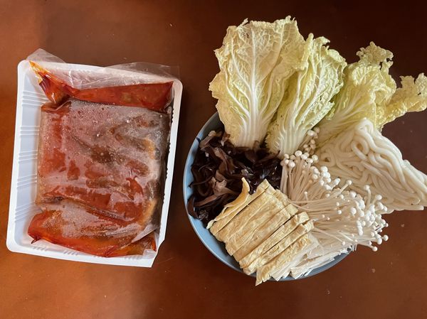 鍋底有六塊豆腐，娃娃菜洗淨，木耳切絲，豆包切長條狀