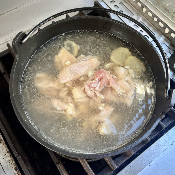 雞腿肉塊瀝去米酒後入鍋，加入魚露後轉小火。