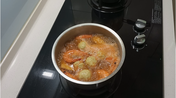 叻沙鍋中放入油豆腐及鮮蝦，再煮3~5分鐘。