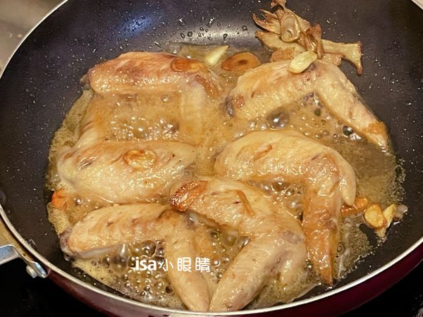 加入米酒與鰹魚醬油，不要太多，然後記得翻面，確保雞翅兩面都能上色。