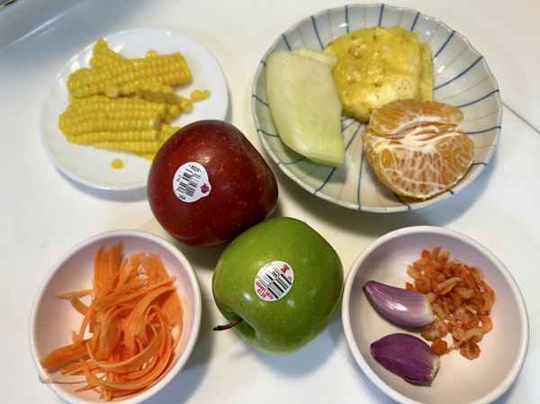 準備喜歡的新鮮蔬果，這次包括華盛頓翠玉蘋果（青蘋果）、華盛頓富士蘋果、鳳梨、哈蜜瓜、橘子、玉米（煮熟）和紅蘿蔔絲，以及蝦米和新鮮紅蔥頭。
將所有食材洗乾淨並切塊備用。