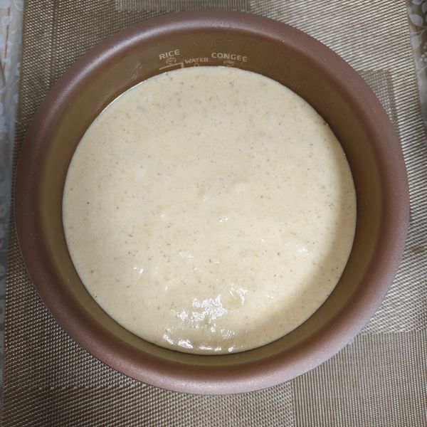 倒入已事先抹好油的內鍋，再將鍋子拿起輕放下敲個一兩下震出大氣泡，避免內部產生大空隙，再放入電子鍋內，蓋上蓋子按下蛋糕鍵（時間是原本設定好的一次烤45分鐘）及按下開始烹飪鍵，再重複一次，總共2遍共90分鐘。