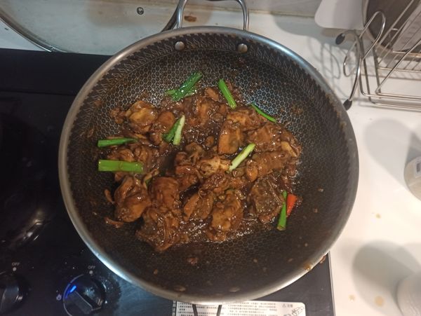 悶燒至醬汁收乾，雞肉呈醬油膏般的金黃色澤，再加入九層塔、辣椒，稍微翻炒後即可起鍋。