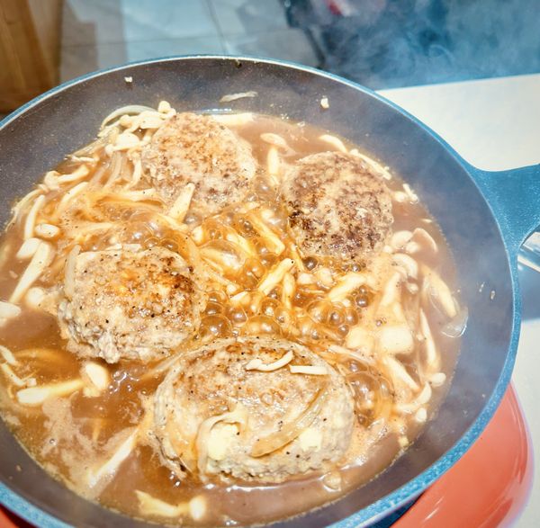 加入醬汁（味霖、米酒、醬油、伍斯特醬、水、番茄醬、黑胡椒粉、細砂糖）拌勻後煮至沸騰。放入漢堡排並蓋上鍋蓋燜煮7-9分鐘。