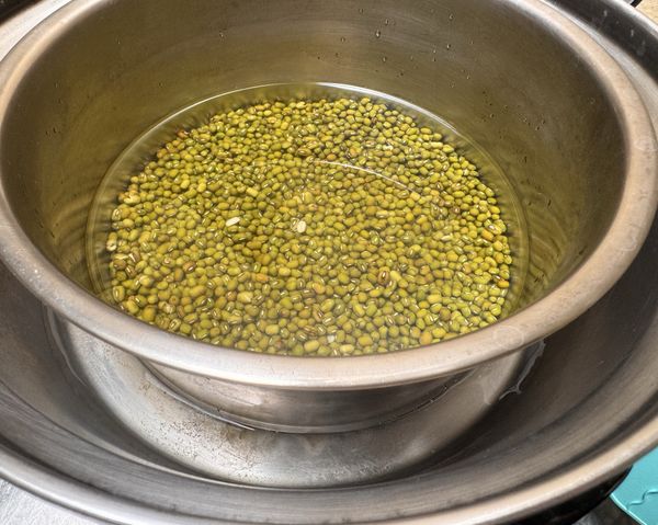 加水蓋過綠豆，水位高過綠豆約1公分高，加入1小匙鹽巴，電鍋外鍋放2杯水，開蒸，
電鍋跳起來後，悶30分鐘