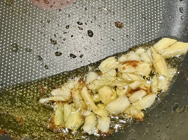 今天先做另一道菜煎雞腿排，用煎腿排冒出的油脂來炒小松菜，鍋小火加油放蒜末爆香，油量不多可以將鍋傾斜集中油脂較好爆香。