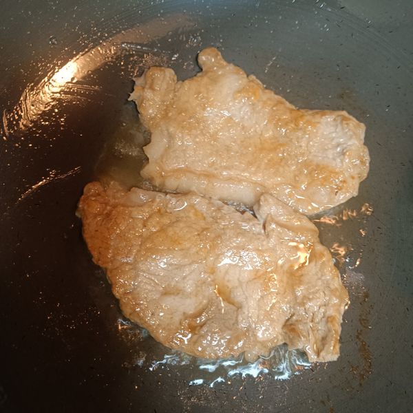 取出要醃製好的豬里肌肉排，鍋熱油放入豬里肌肉排，用中小火煎至變色，翻面繼續煎另一面至熟透