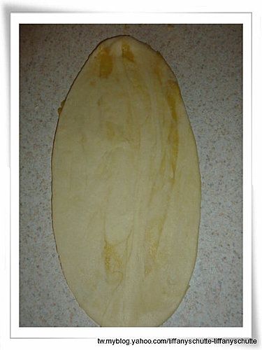 將小圓團壓扁,用桿麵棍桿成橢圓形薄片