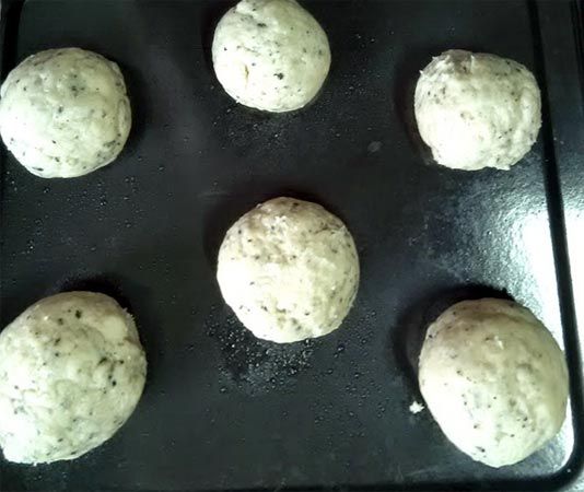 將麵團分成6份分別滾圓後放在烤盤上，在表面噴一些水