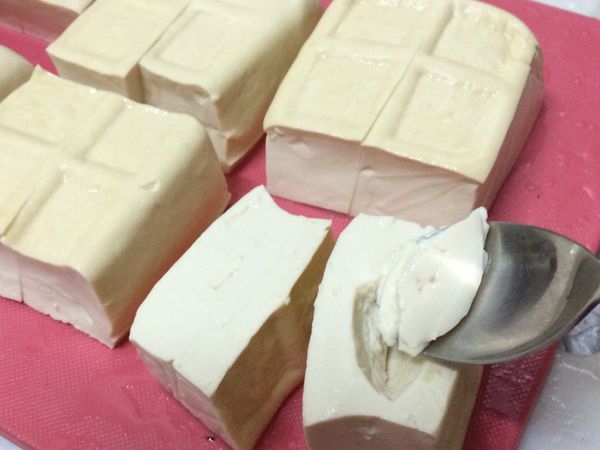 每塊豆腐對切，在切面以小湯匙各挖一個凹槽