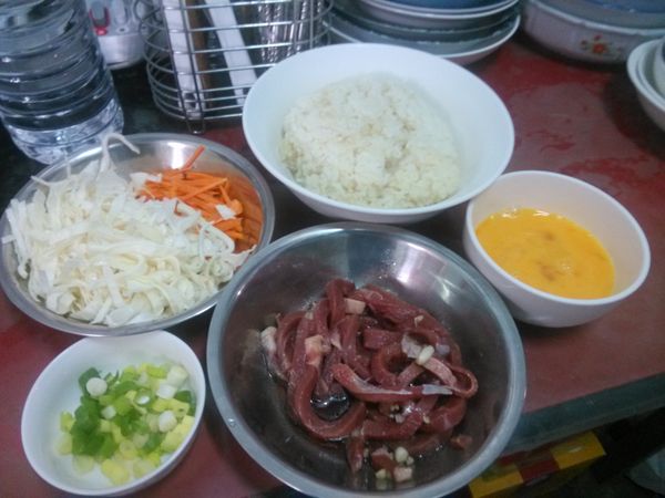 雞蛋打散備用；蒜頭去皮切成細末，並且與牛肉絲加上適量的醬油、味琳或米酒與食用油攪拌均勻；紅蘿蔔洗淨削皮切絲；高麗菜洗淨切絲；青蔥切成蔥花。