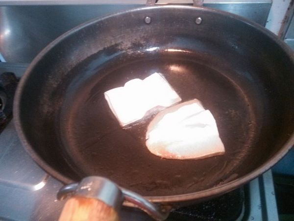 鍋中加入適量的油，將魚片放入油煎。