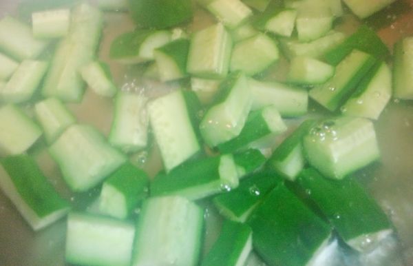 取鍋，用滾水川燙已切好的小黃瓜並且瀝乾水分；（川燙的水中加少許鹽和蔬菜油，可以幫助保持小黃瓜的顏色）