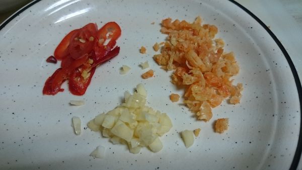 空心菜除去老梗，梗和葉子分開挑好（用切的也是，把梗和葉子分開）。辣椒切斜片。大蒜壓扁切片。蝦沖乾淨，泡水後取出剁碎。紅蔥頭切片。（這次的照片沒有紅蔥頭）