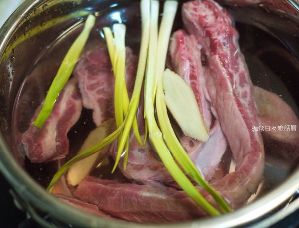 牛肋條清洗後放入冷水鍋，放入蔥和２片薑片，
 
煮至沸騰，關火取出沖去浮末，切塊