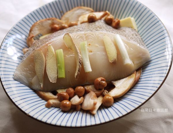 淋上破布子和其湯汁，在鱈魚片上擺薑片和蔥段