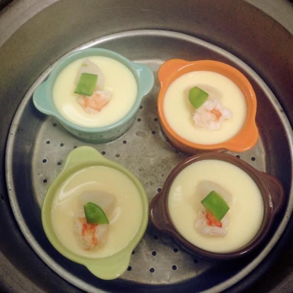 蛋汁漸漸有凝固感時,把已經川燙後的配料擺設其中,若是還水水的時候放,料很容易沉下去,隨時注意電鍋狀況,完全凝固時就表示可以上桌囉!!