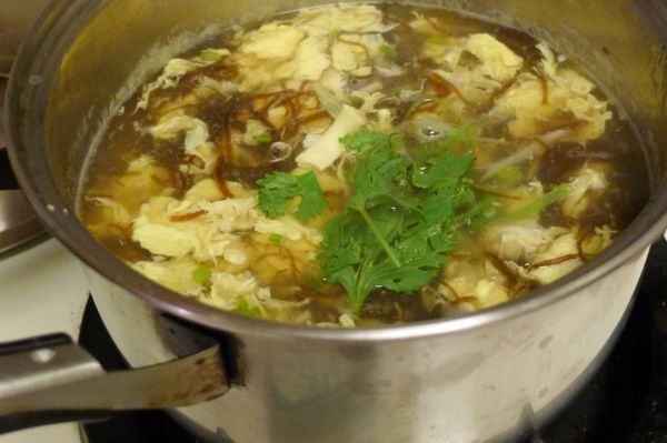 再將蛋液倒入，攪拌均勻，起鍋前放入蔥絲、香菜、灑些許麻油