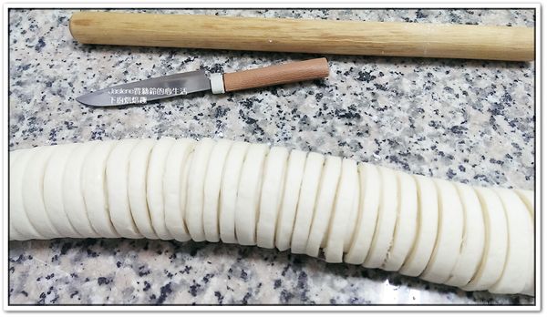 接著將麵糰捲起，從撒蔥花的那邊開始捲