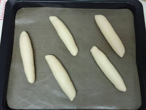 將捲好的麵團一一排放在舖有不沾烘焙布(紙)的烤盤上，表面噴點水，送進烤箱，做最後發酵１小時。