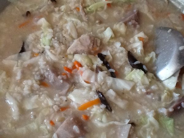 加入乾飯，煮至米飯軟有黏稠性出現，再加入高麗菜，菜熟後即可。