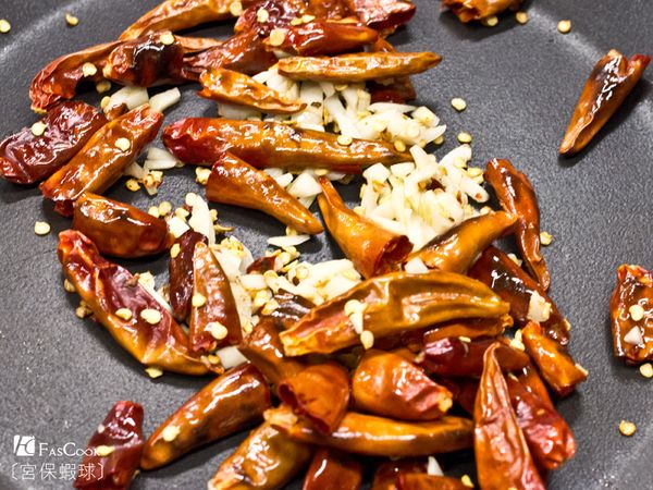 將花椒粒下鍋炒香後撈起花椒粒，將乾辣椒及蒜末、薑末下鍋爆香