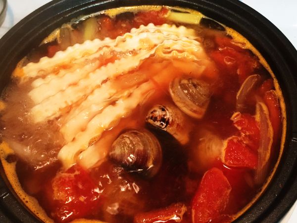 放入關廟麵煮3分鐘，加入蛤蜊，再煮2分鐘