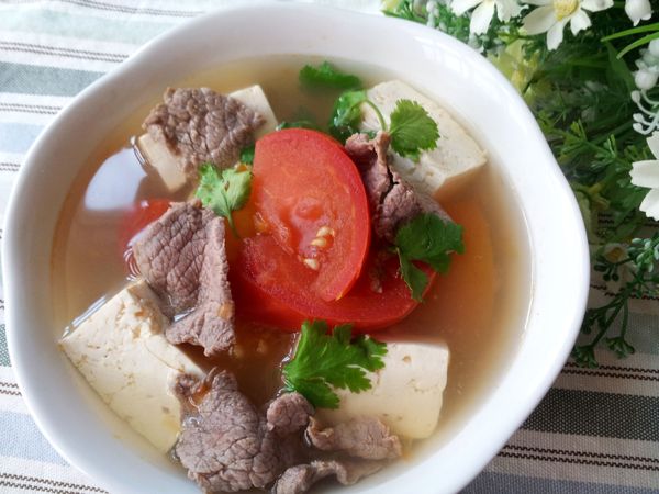 牛肉洗淨瀝乾水 , 把醃料加入拌勻 , 醃約30分鐘 ; 
蕃茄洗淨切滾刀塊 ;   板豆腐切丁 ; 香菜洗淨瀝乾