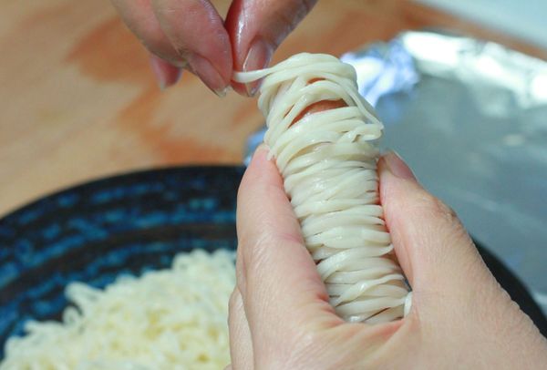 將熱狗捲上乾意麵，做成木乃伊的造型放入烤箱烘烤一下定型