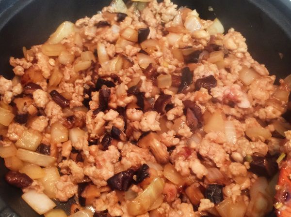 加入絞肉、糖炒至上色，加入白胡椒粉、五香粉、油蔥酥拌炒