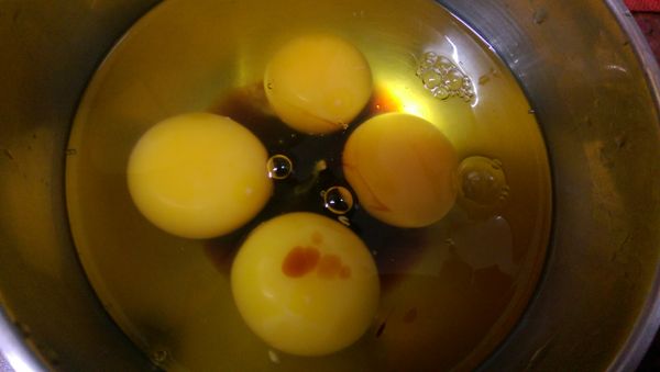 取一大碗.打入四顆蛋.加2小匙醬油