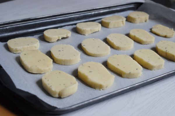 餅乾團拿出，用刀切約0.3分厚的薄片，整齊排在鋪有烘焙紙的烤盤上