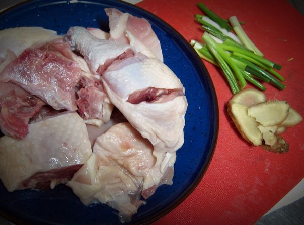 雞腿洗淨切塊，加入2片薑片及些許葱段，川燙去血水後撈起以冷水沖洗後，加入1匙酒略抓（去腥味）備用。